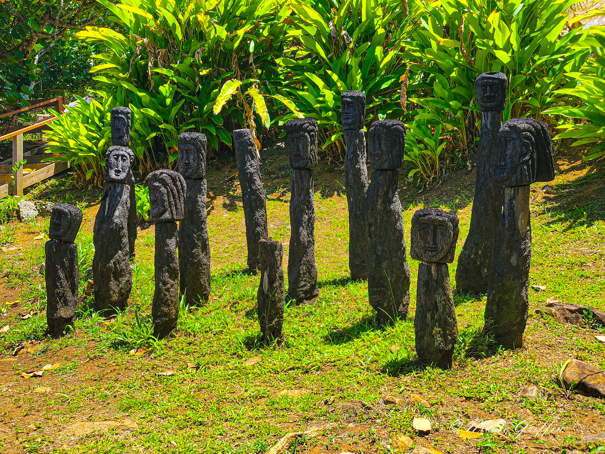 black pieces of wood carved as faces