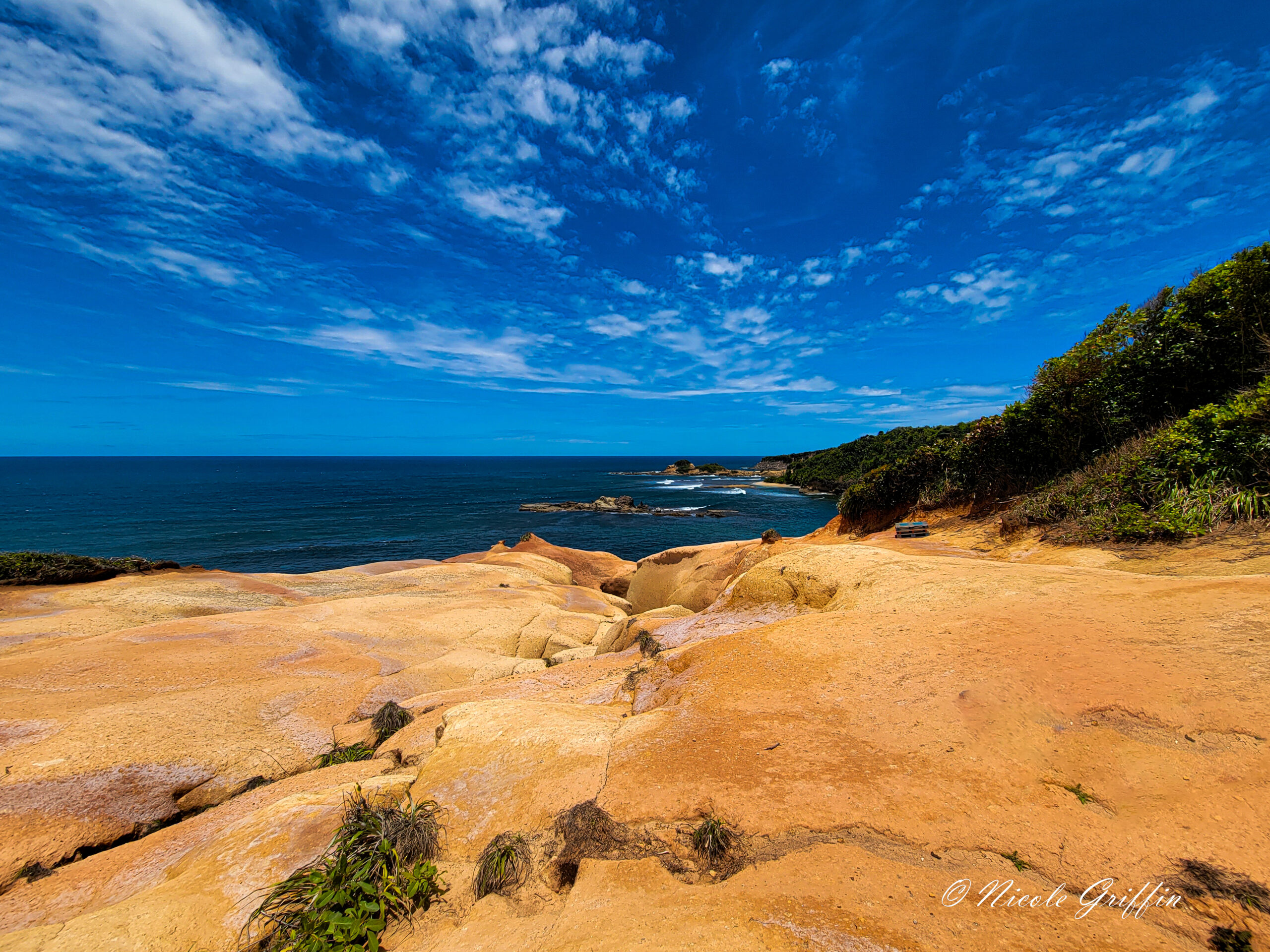 red rocks by deep blue waters