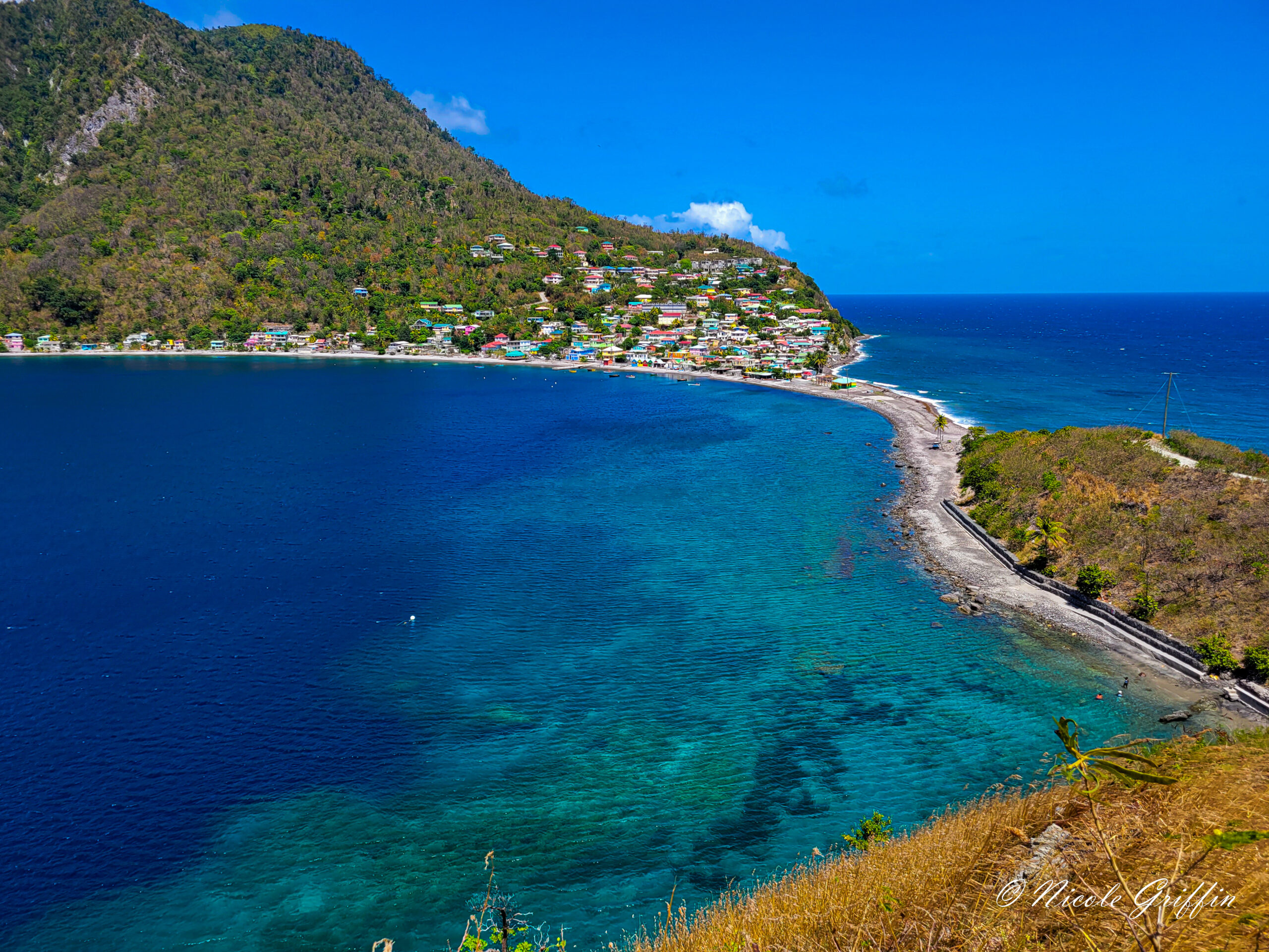 a colorful village at the tip of a peninsula